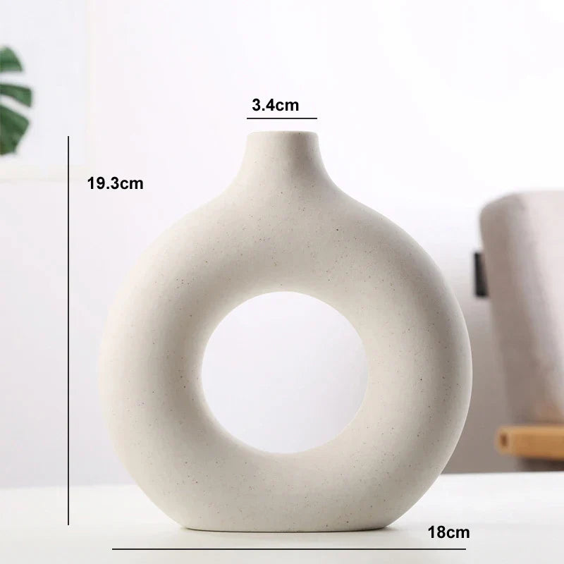 Stone-textured ceramic circular vase in natural calming tones, minimalist organic silhouette for home decor
