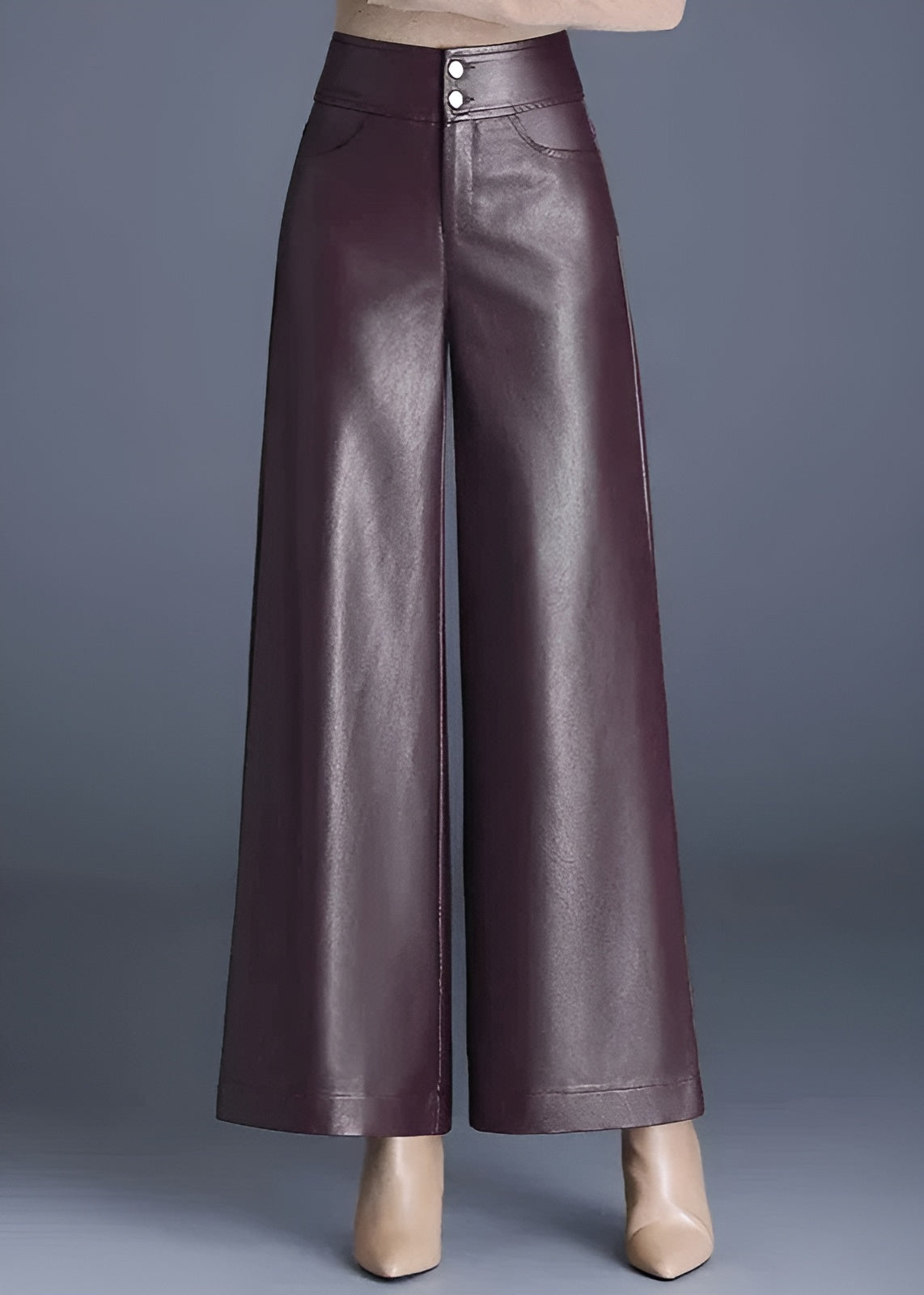 Black high-rise flared vegan leather pants with glossy finish and wide-leg silhouette