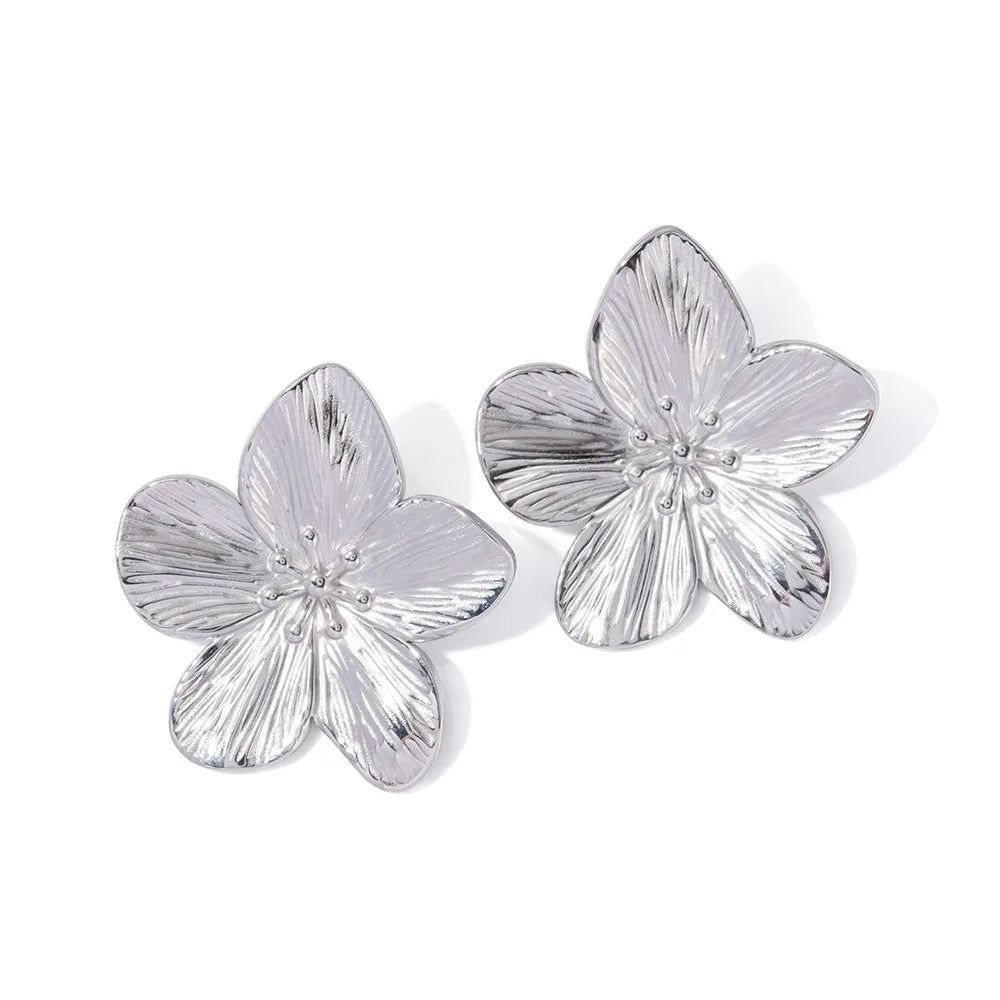 Oversized gold-tone floral statement earrings with bold five-petal design and textured veining finish