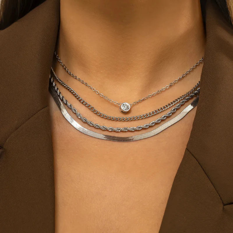 Renata layered gold-tone necklace with twisted multi-strand chains and bold pendant, adjustable fit