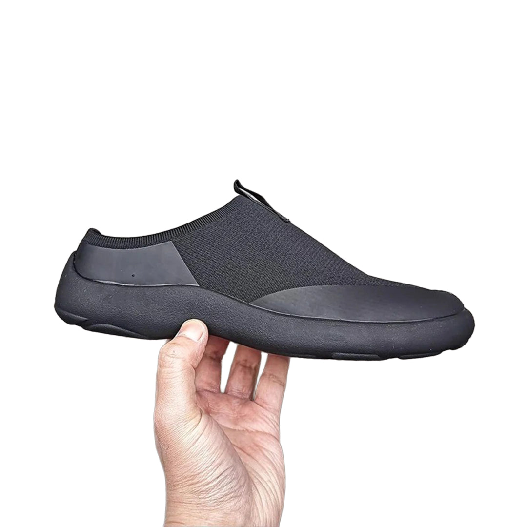 Black minimalist slip-on sneakers with bold split-toe tabi silhouette for modern casual wear