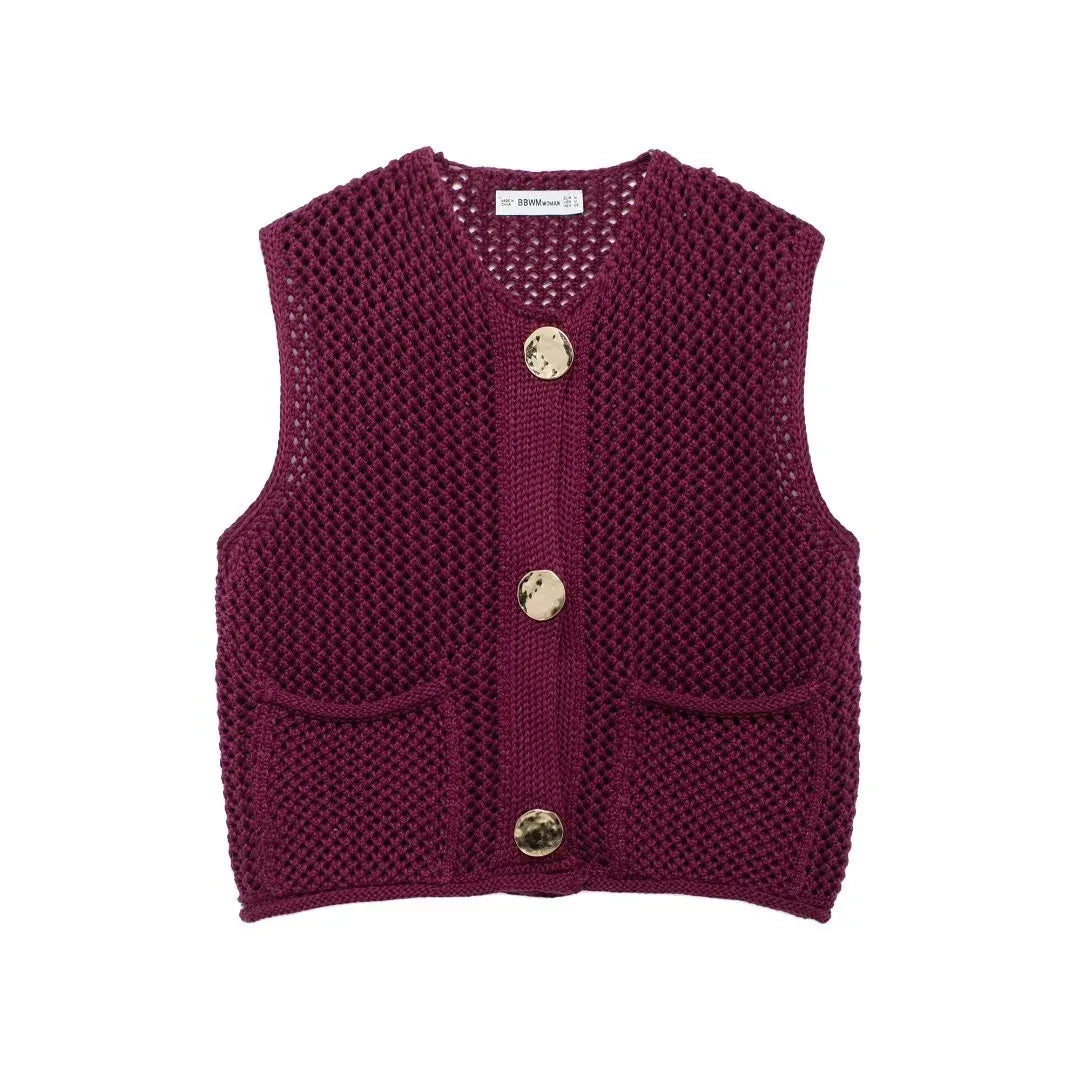 Knitted vest with open-knit texture, oversized buttons, relaxed fit, functional pockets for everyday layering