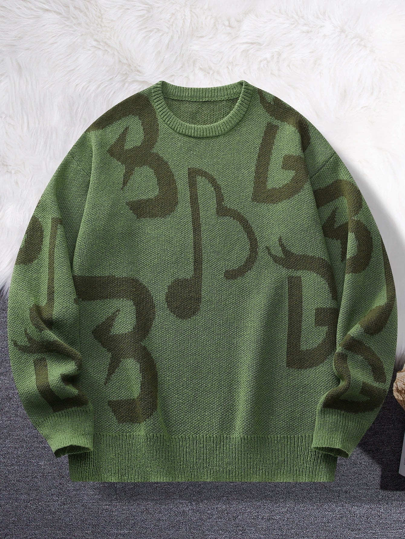 Black and white knit sweater with bold oversized music note pattern, cozy soft fabric for creative style