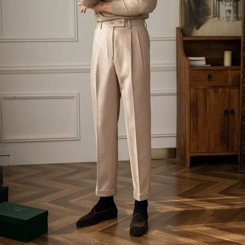 Men's high waisted wool blend pants in neutral tone, slim tapered cut with elongated silhouette