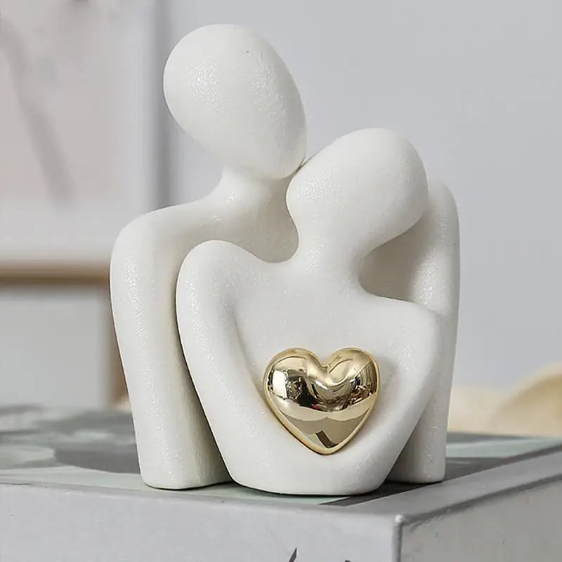 Matte black ceramic abstract sculpture with polished golden heart accent, modern minimalist home decor piece