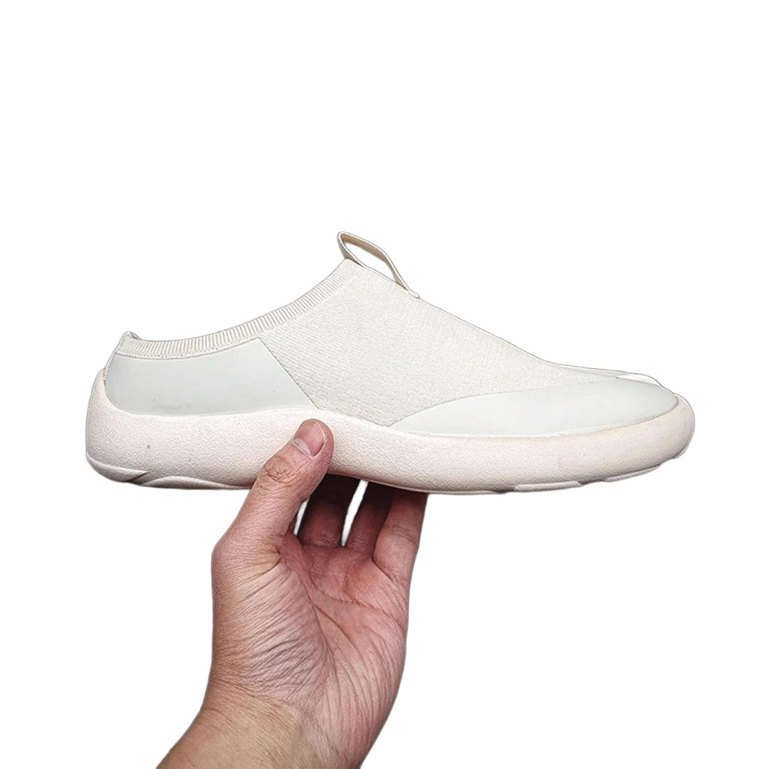 Minimalist black slip-on sneakers with bold split-toe tabi silhouette in polyester-nylon construction