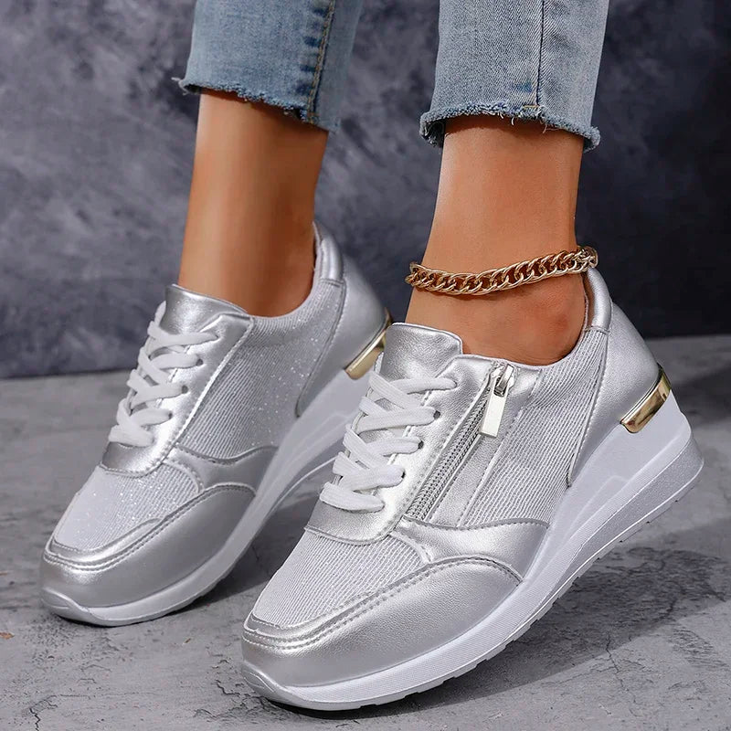 Women's white platform sneakers with metallic accents, lace-up closure, and cushioned sole for all-day comfort