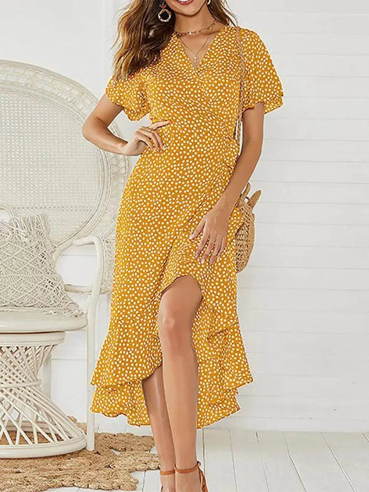 White polka dot maxi dress flutter sleeves V-neckline ruffled hem breezy vacation silhouette