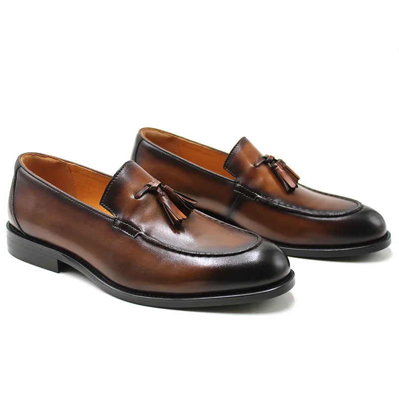 Men's black genuine leather slip-on loafers with tassel detail, classic dress shoe silhouette
