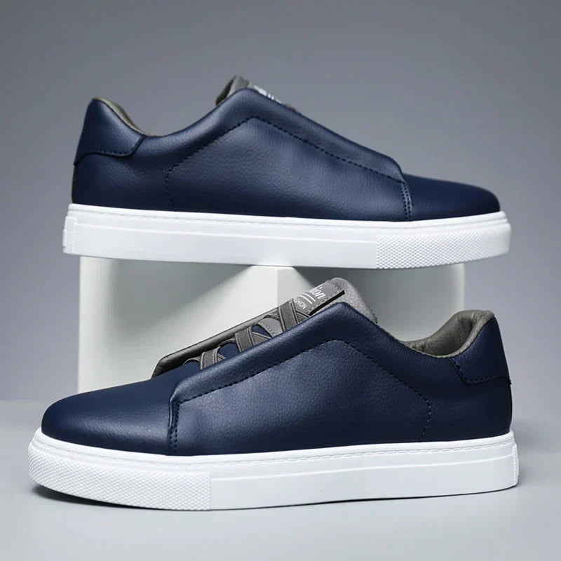 Navy faux leather low top slip-on sneaker for men with thick white sole and sleek everyday fit