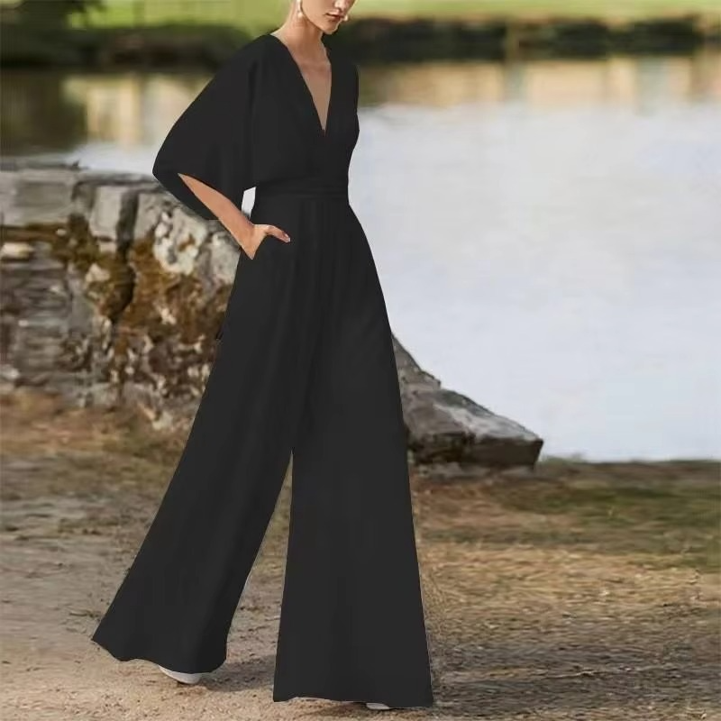 Women's solid color low-waist wide-leg jumpsuit with side button closure, sleek commuter style