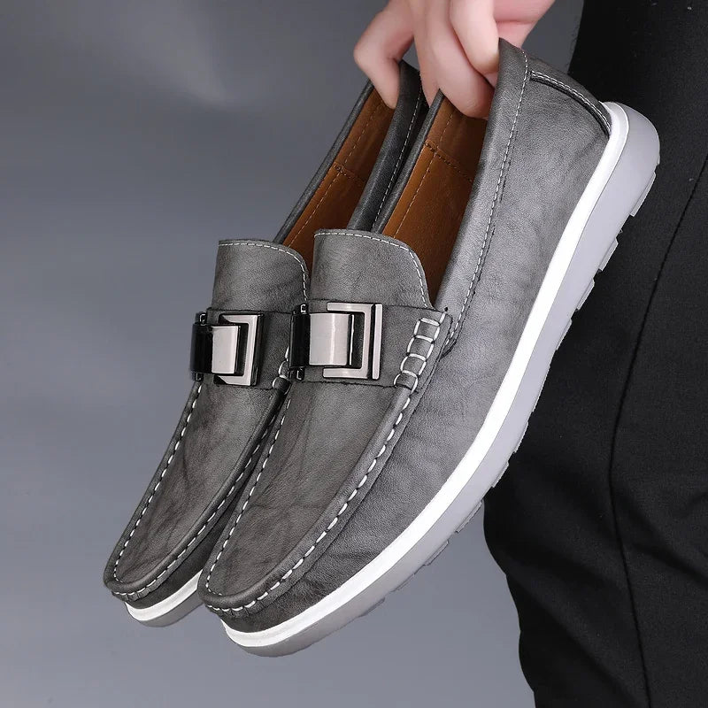 Brown textured leather loafers with gloss buckle detail and contrast stitching for a polished look