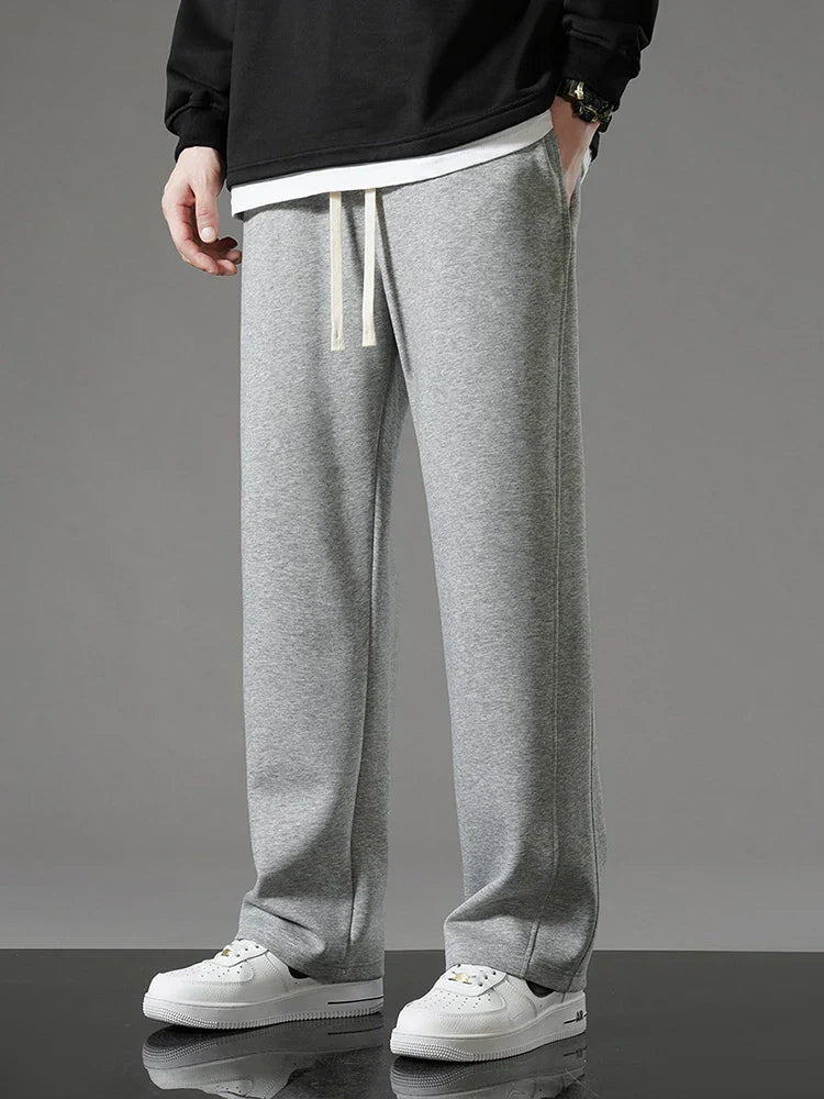 Men's relaxed fit sweatpants in neutral tone, soft fabric casual lounge style with roomy silhouette