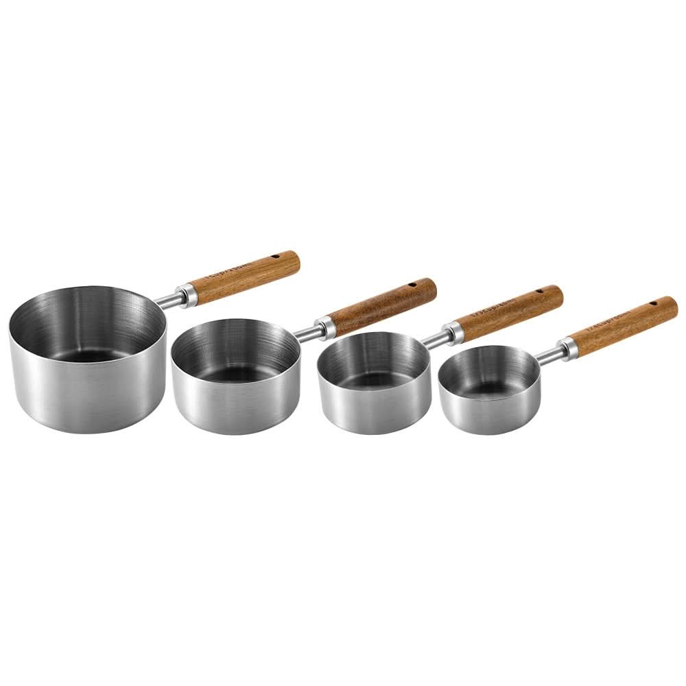 Gold-toned metal measuring cup set with wood handles, engraved markings, elegant kitchen tool