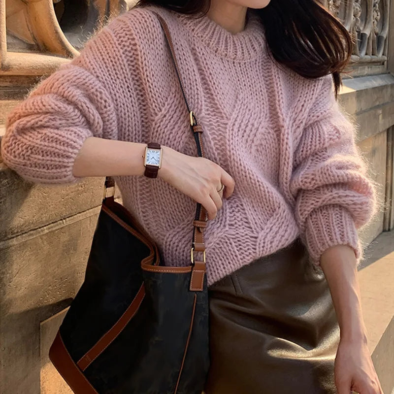 Women's oversized cable knit sweater cozy wool texture long sleeves relaxed silhouette cold-weather style
