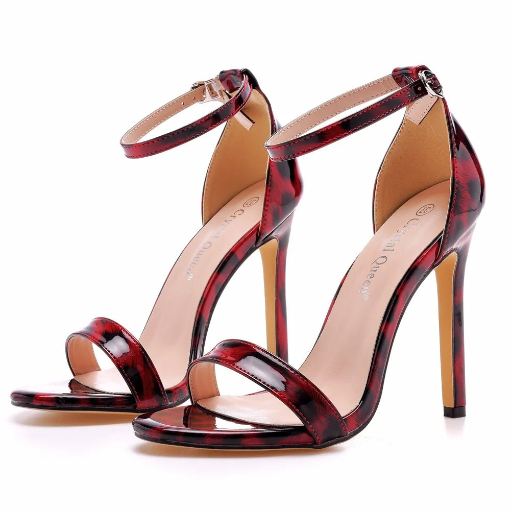 Crystal-embellished strappy stiletto open-toe heels in nude or cheetah print with gold ankle charm