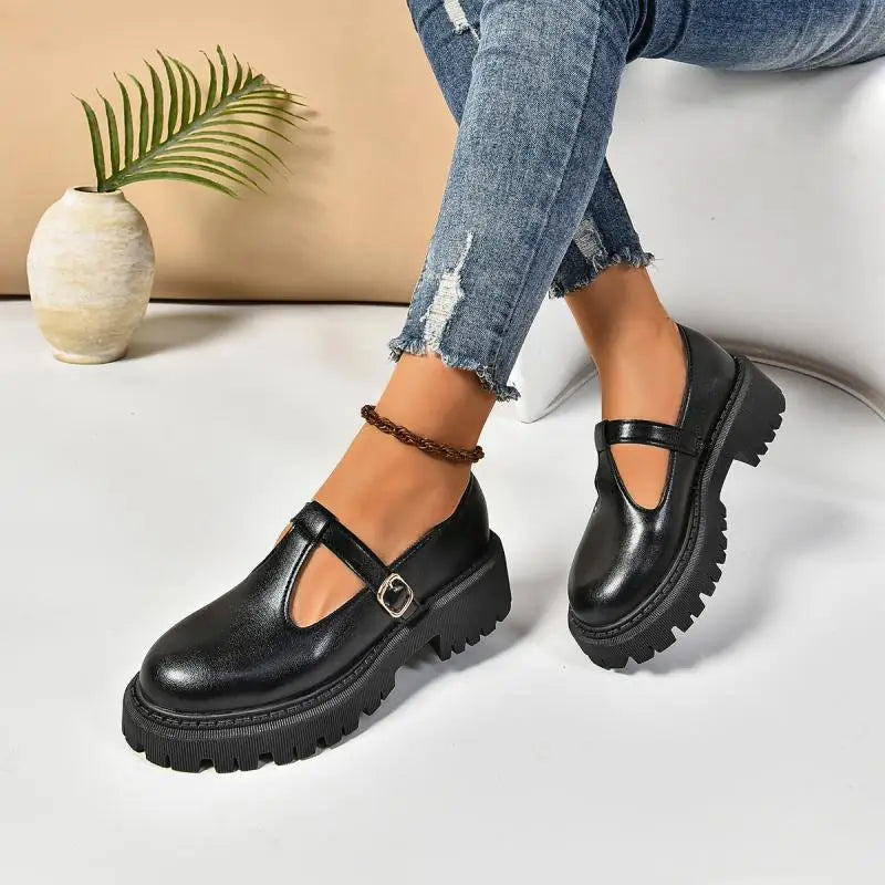 Women's black buckled platform shoe with chunky rubber sole, retro-inspired style and all-day comfort