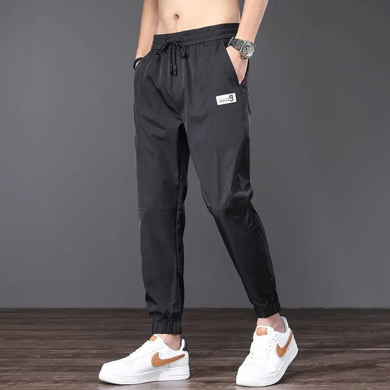 Unisex tapered nylon-blend jogger with light-shifting gradient pattern, lightweight breathable street athletic fit