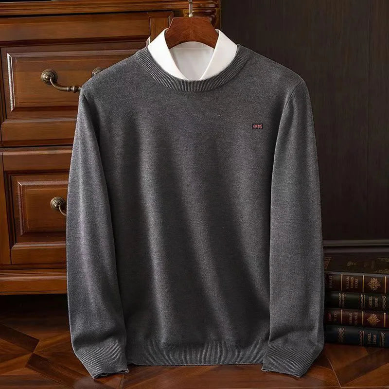 Lightweight crewneck knit sweater in neutral tone, smooth fine-knit texture, unisex tailored fit