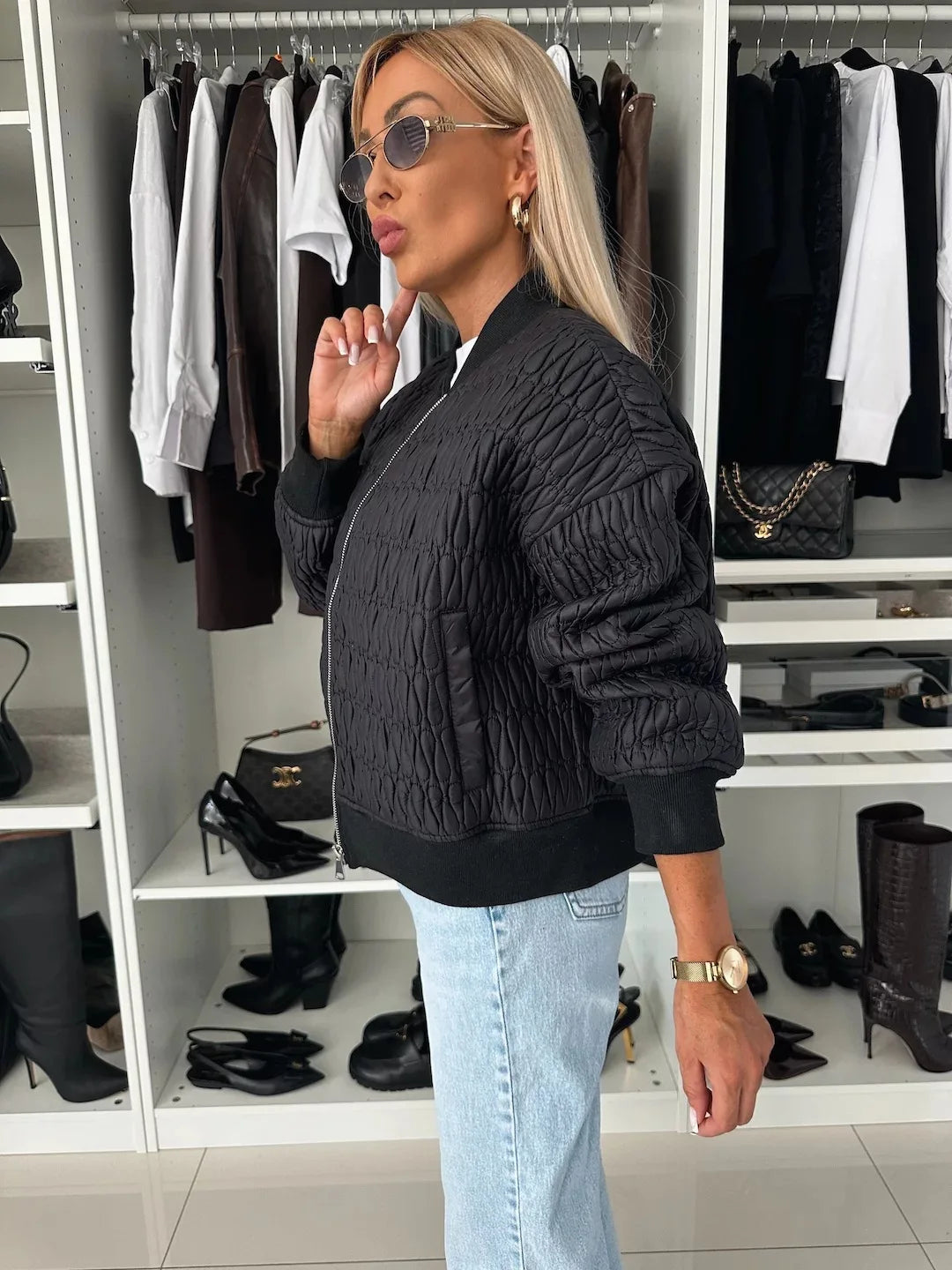 Women's black quilted bomber jacket with sporty-elegant silhouette and textured all-season design
