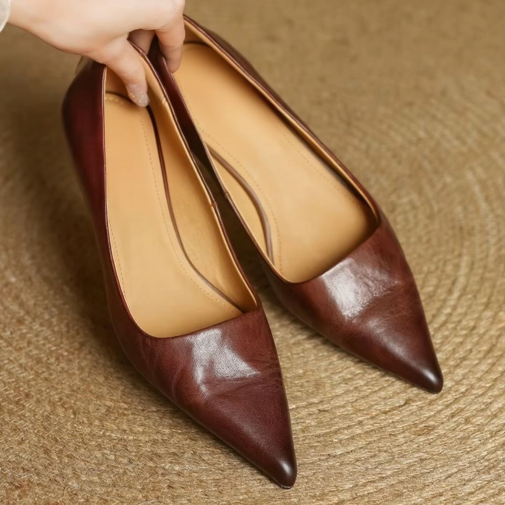 Women's black genuine leather pointed toe slip-on pumps with sleek professional silhouette