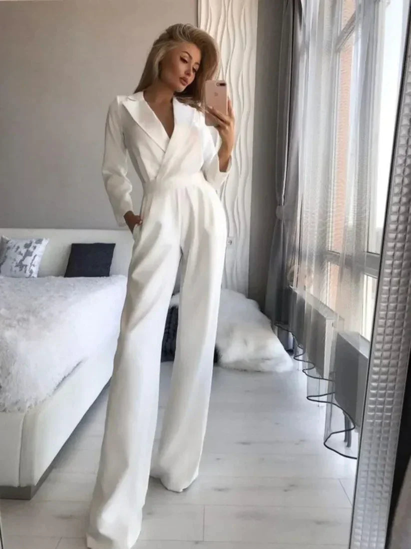 Women's black tailored wide-leg jumpsuit with V-neck long sleeves and elegant draping silhouette