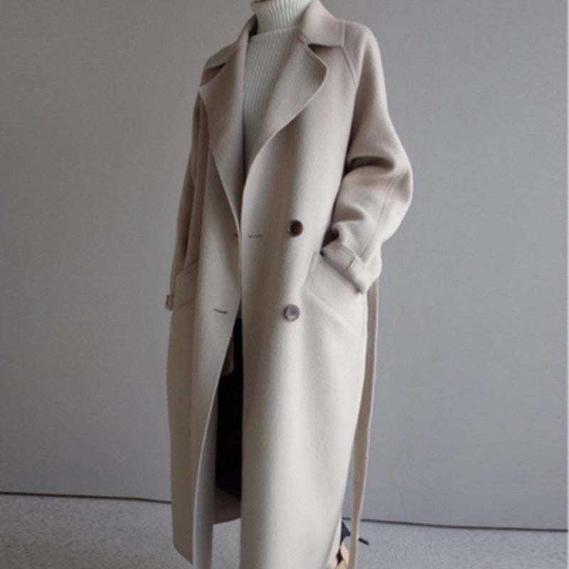 Beige long trench coat relaxed silhouette clean minimal drape double button front closure