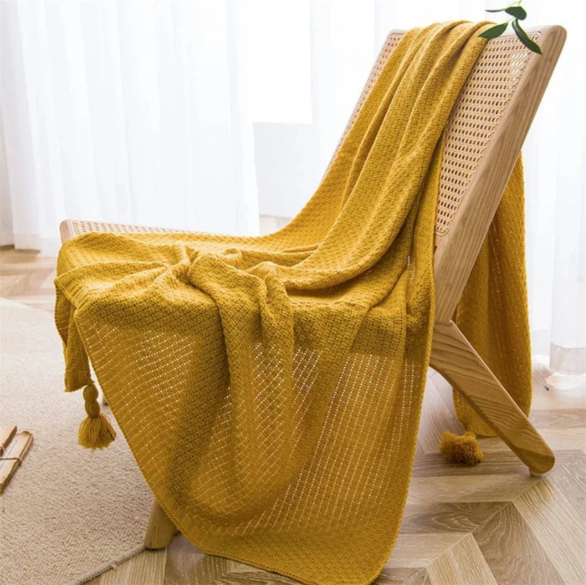 Cream handknit Nordic throw blanket with tassel fringe, ultra-soft cozy style for beds and couches