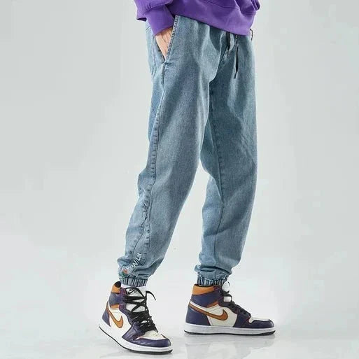 Urban denim jogger pants in classic blue, relaxed tapered cut with elastic waistband for active comfort