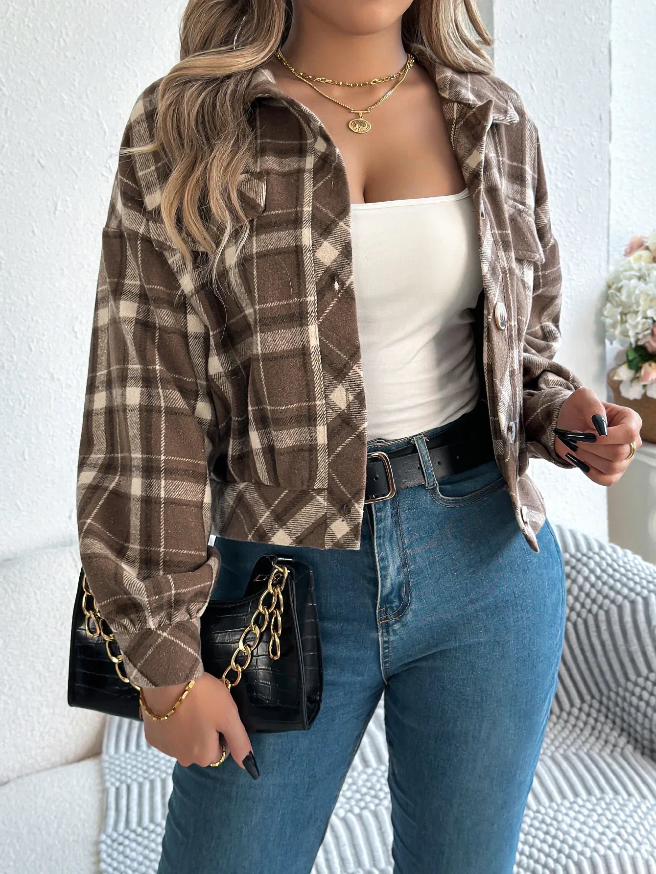 Women's cropped plaid jacket in warm tones, waist-length silhouette with bold brushed fabric pattern