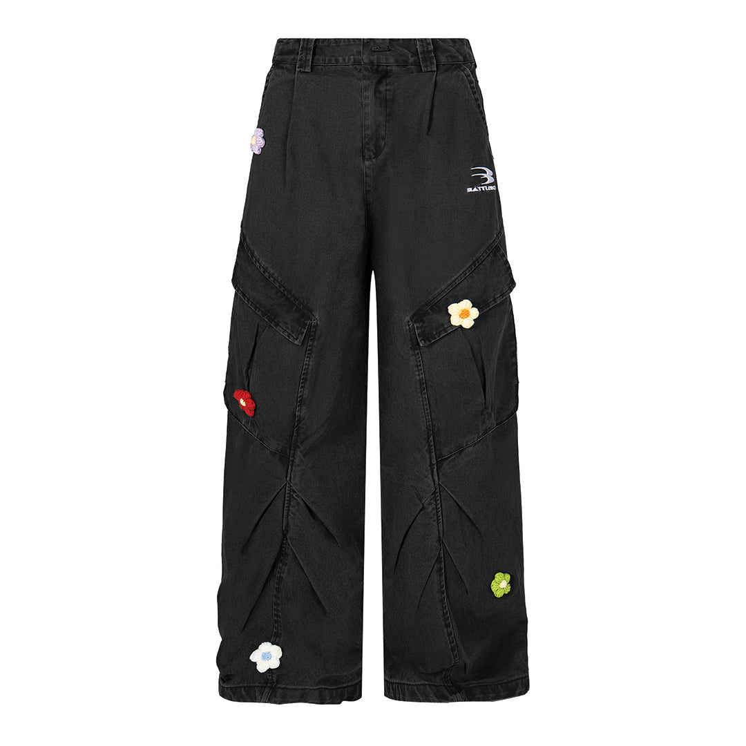 Blue loose-fit denim cargo trousers with knit flower accents for casual streetwear styling