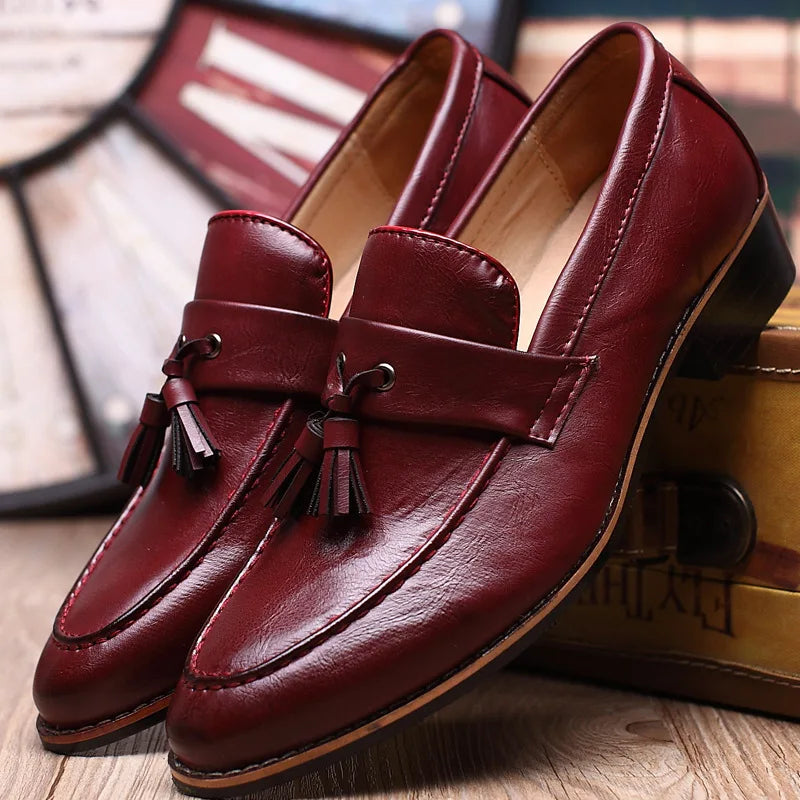 Brown leather loafers moccasin-style with stitched toe detail, polished professional slip-on design