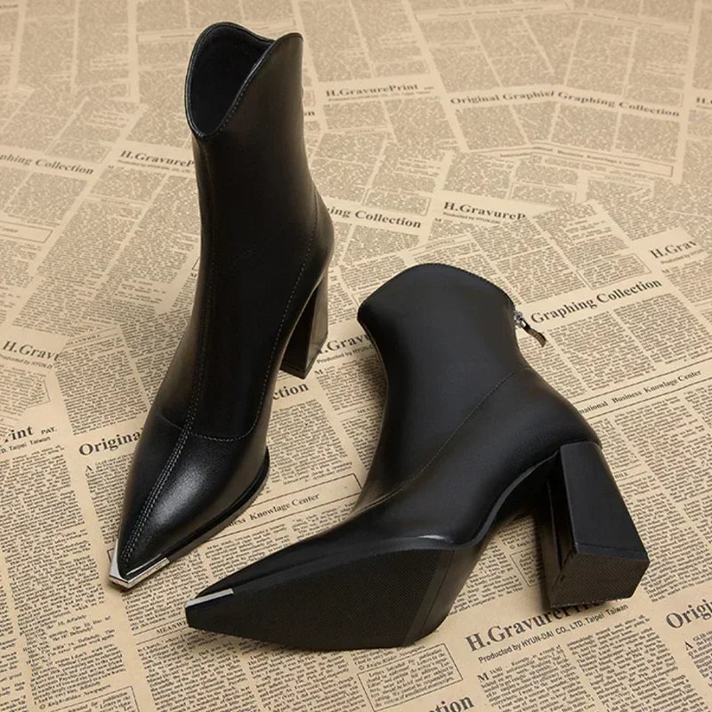 Women's dark faux leather Chelsea ankle boot with sleek chrome toe tip and smooth premium finish