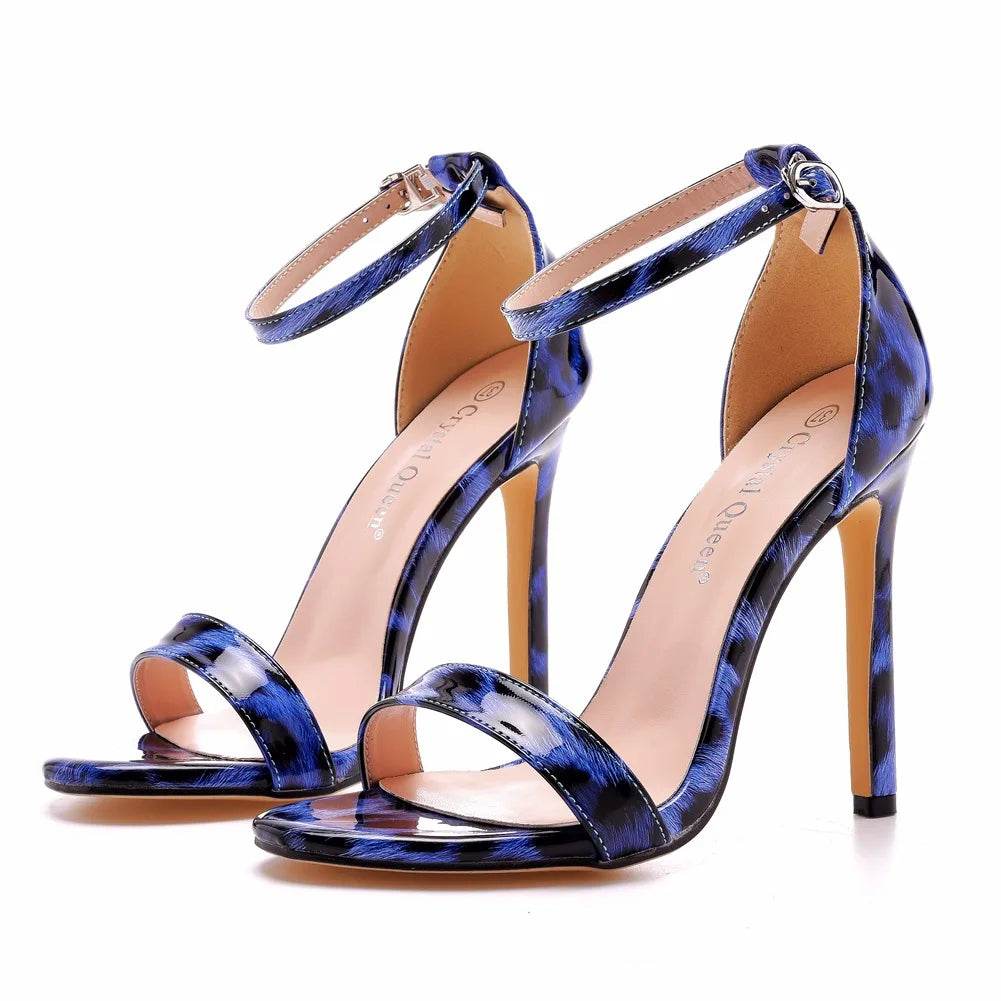 Crystal embellished strappy stiletto open-toe heels in nude cheetah print with gold ankle strap charm