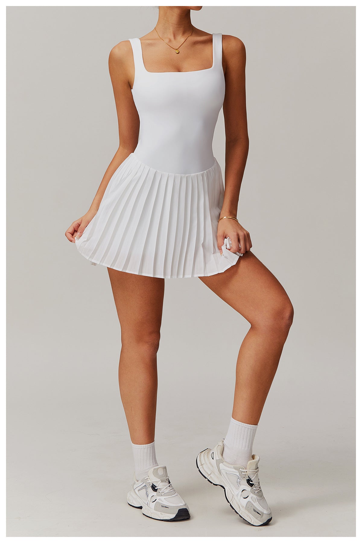 White sleeveless tennis tank dress with built-in support, breathable moisture-wicking one-piece athletic fit