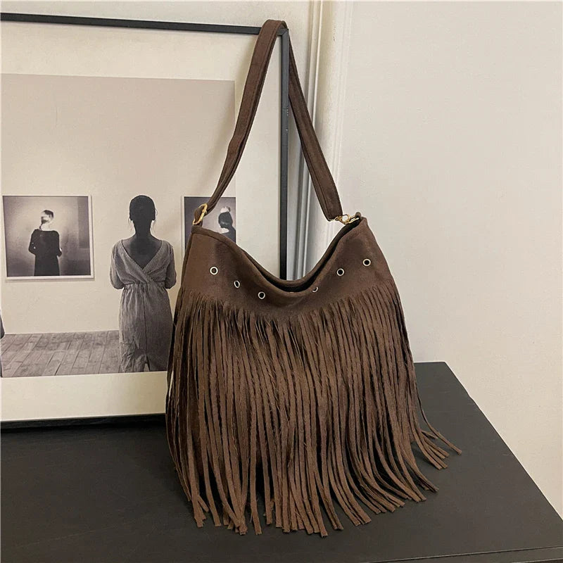 Boho faux suede fringe shoulder bag with eyelet details, lightweight hobo silhouette for festival style