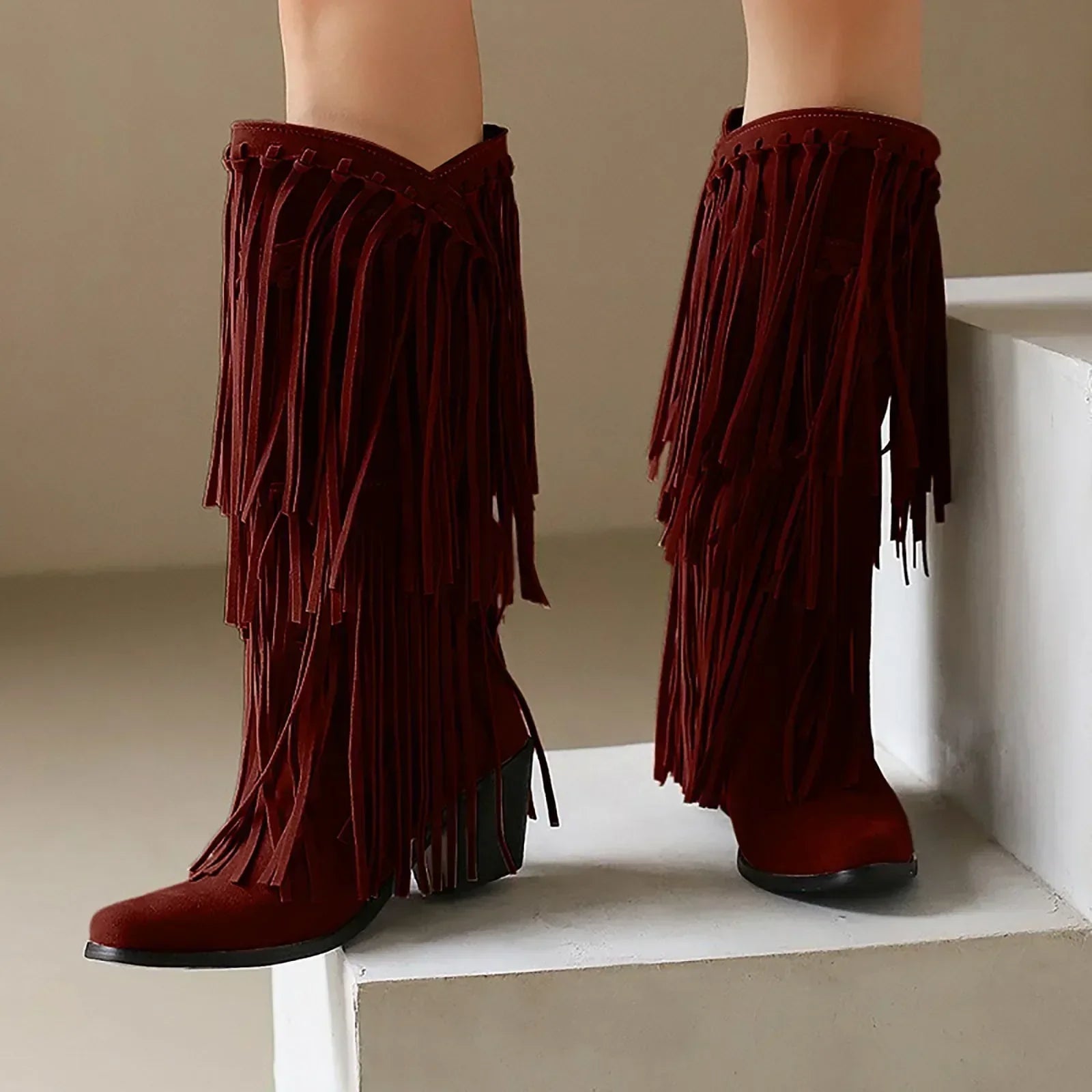 Women's western knee-high boots with long flowing fringe detailing and sturdy block heel