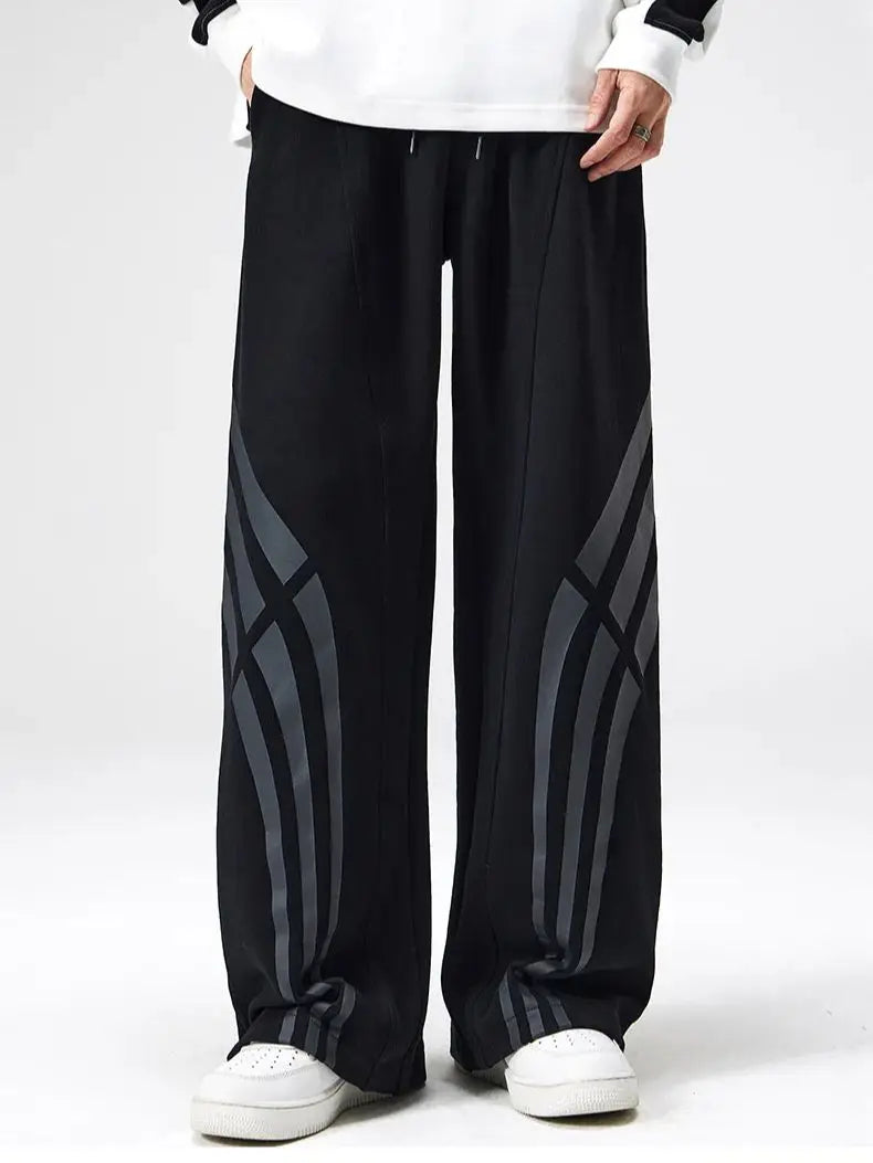 Black straight fit sweatpants with warped vintage stripe design and wide flared leg for streetwear