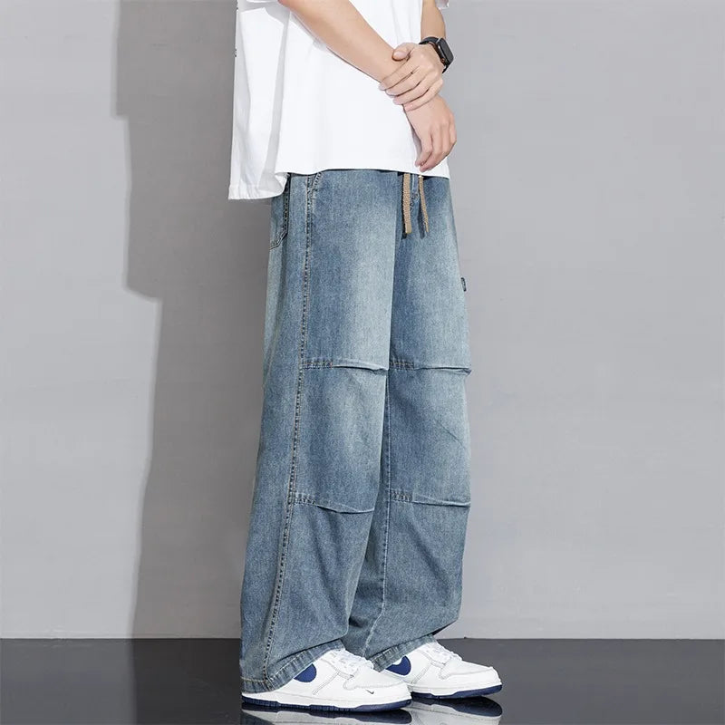 Washed denim wide-leg cargo pants unisex relaxed fit with drawstring waist and faded finish
