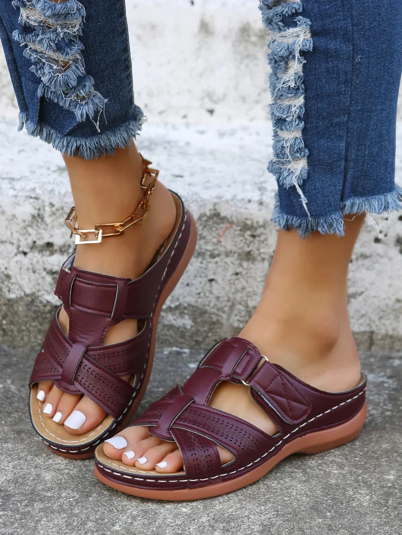 Women's beige openwork slide sandals with criss-cross straps, Velcro closure, and cushioned insole