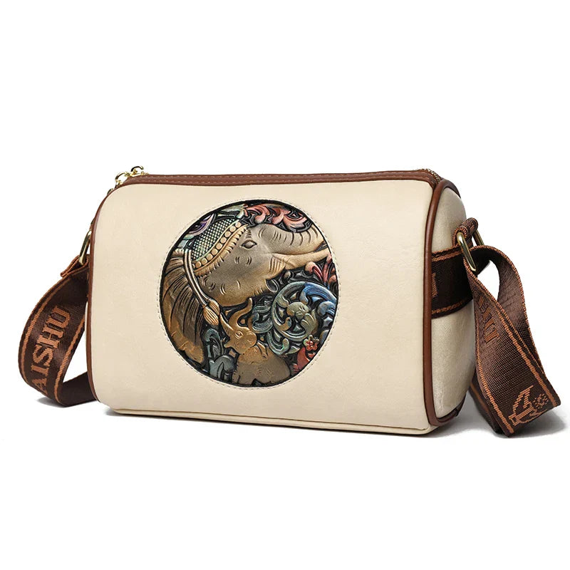 Brown leather shoulder bag with embossed circular elephant motif, blending artisan detail and everyday style