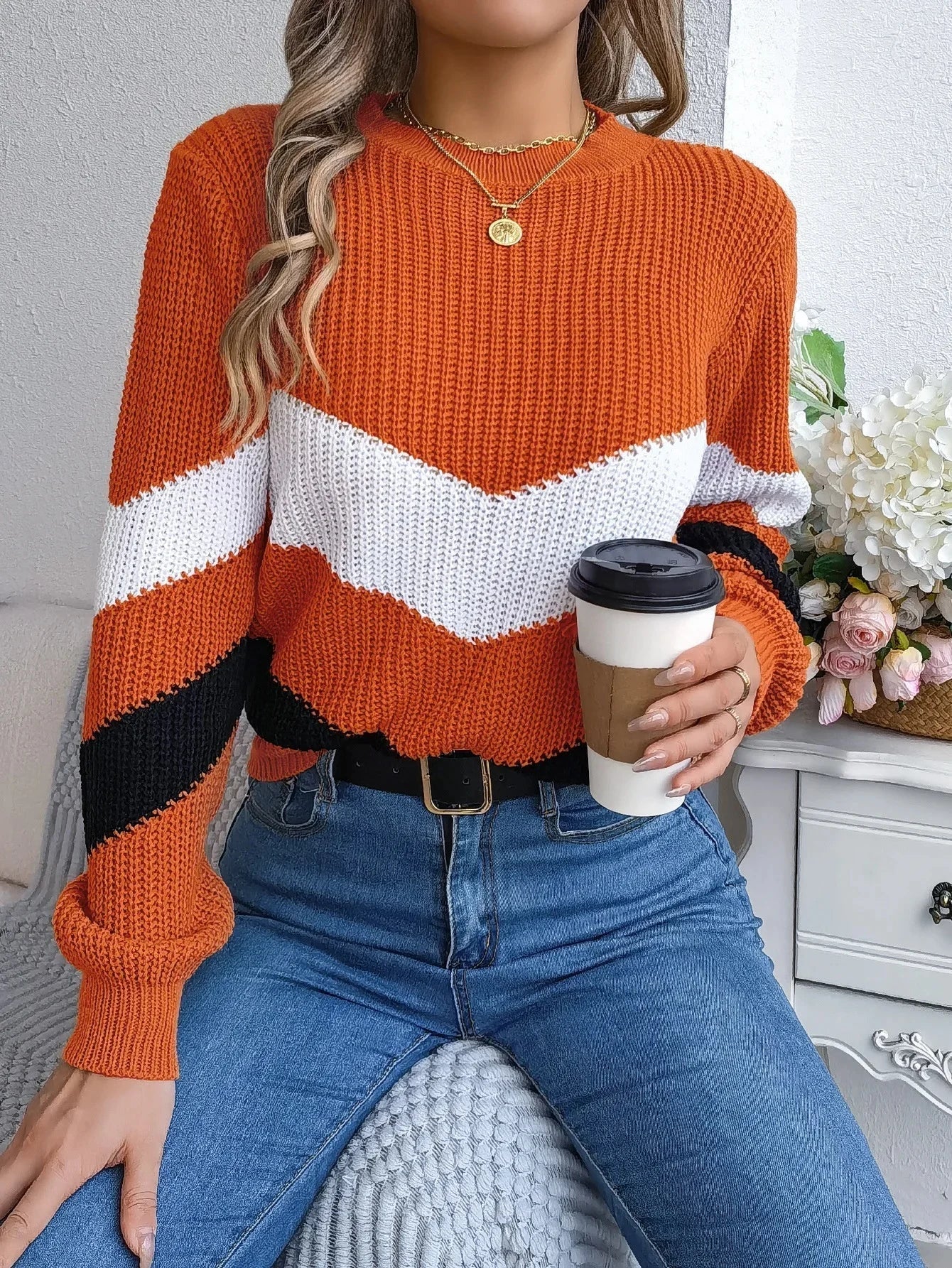 Women's cashmere turtleneck sweater with bold chevron color-block pattern, relaxed fit for winter warmth