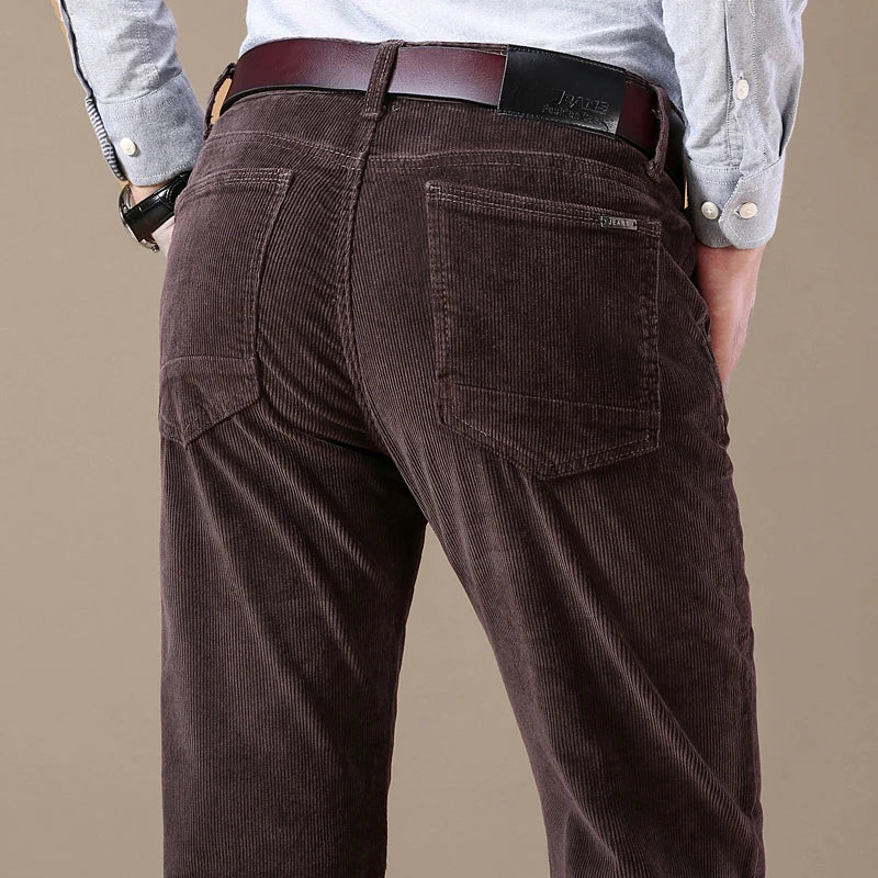 Men's slim-fit elastic corduroy pants in neutral tone with stretch waistband for everyday comfort