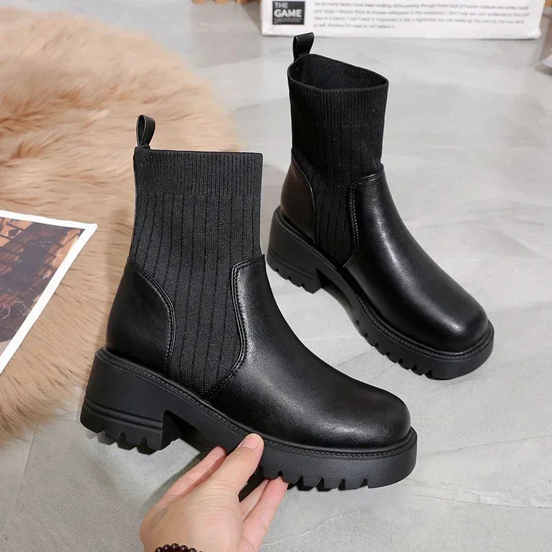 Women's black split-knit platform boots with faux leather accents and rubberized chunky heel