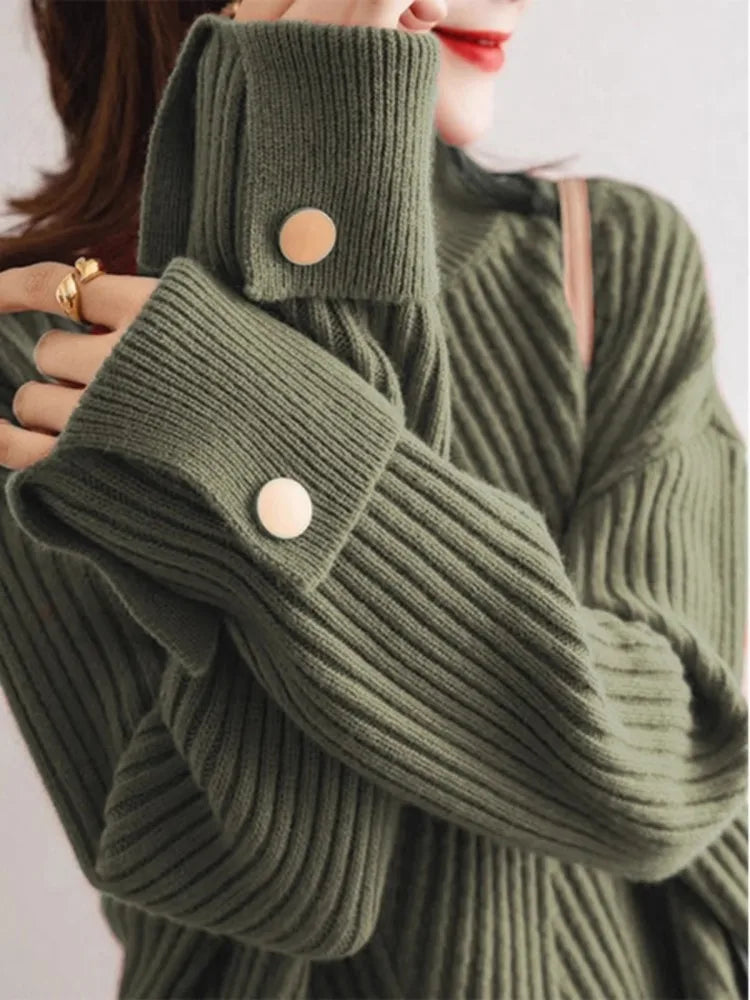 Women ivory oversized ribbed knit pullover sweater with cuffed sleeves and subtle button detail