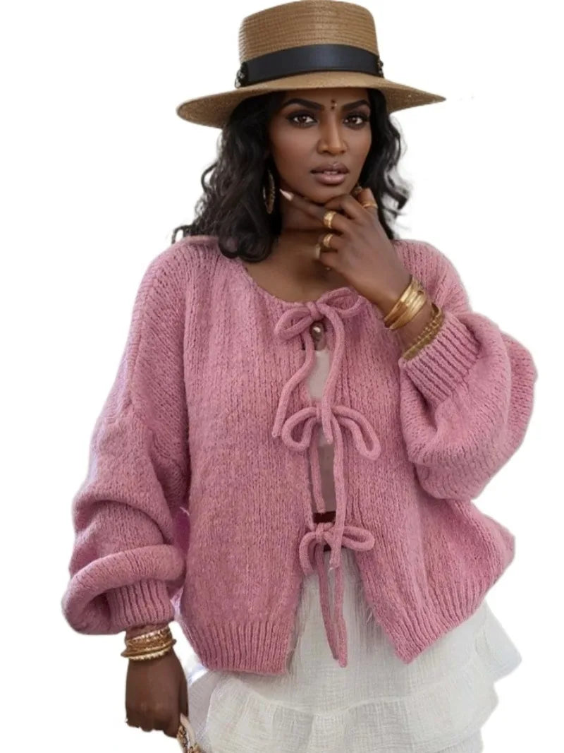 Women's chunky knit winter cardigan with knotted front detail and oversized sleeves in cozy style