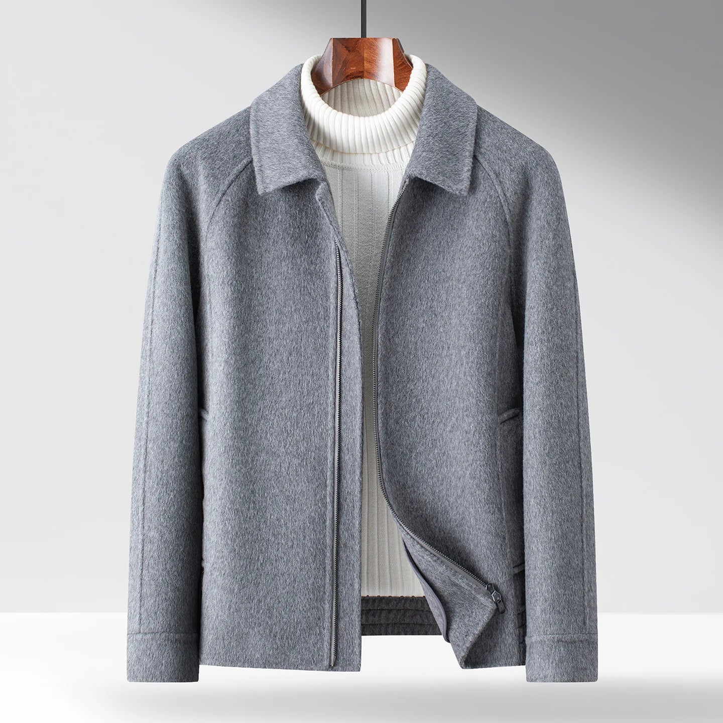 Black minimal zip-up winter jacket with polished collar, smooth interior, clean silhouette for refined layering