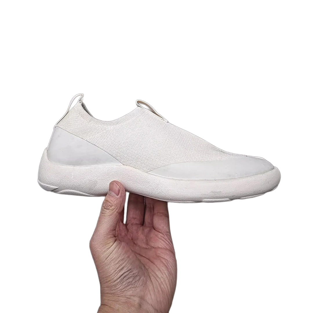 Black minimalist slip-on sneakers with bold split-toe tabi silhouette for modern casual wear
