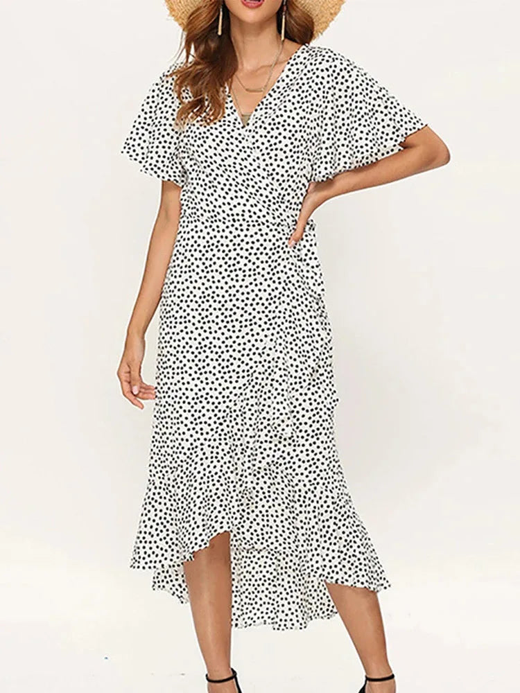 White polka dot maxi dress flutter sleeves V-neckline ruffled hem breezy vacation silhouette