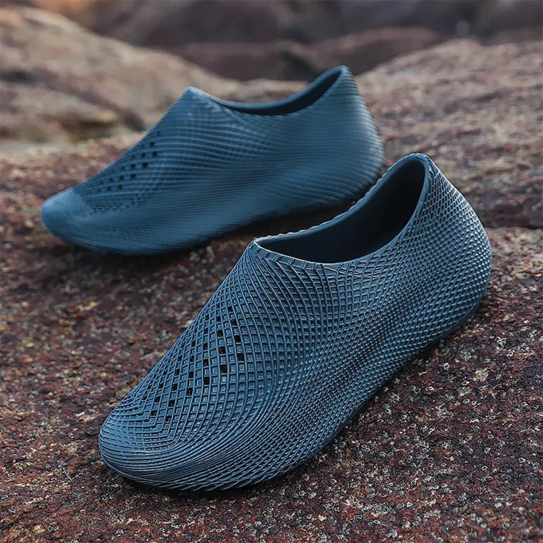 Lightweight white EVA slip-on runner slippers with futuristic kinetic-sculpted contours for athletes